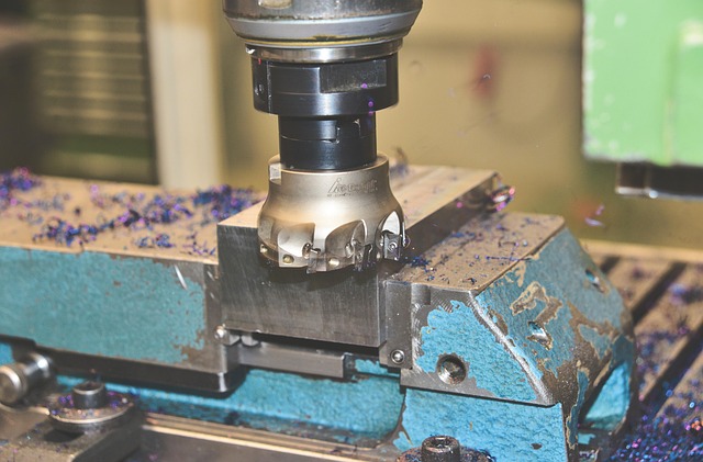 close-up of mechanical model assembly showing screws, gears and calipers on a workshop mat