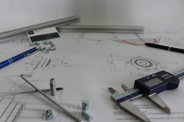 technical notebook with gear sketches and a small model engineering caliper on a workbench